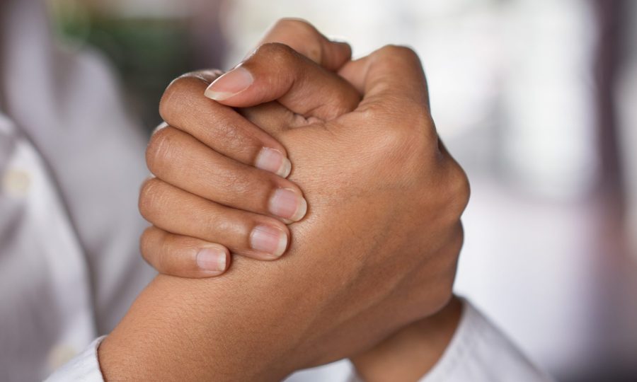 Closeup of two business women clasping hands. Partnership concept. Side view.